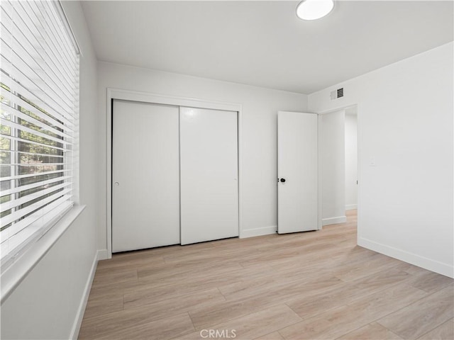 38537 Desert View Dr, Palmdale, CA 93551 - unfurnished bedroom featuring baseboards, light wood-type flooring, and a closet