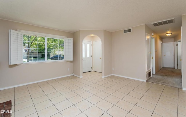 29421 Florabunda Rd, Canyon Country, CA 91387 - empty room featuring arched walkways, baseboards, and light tile patterned flooring