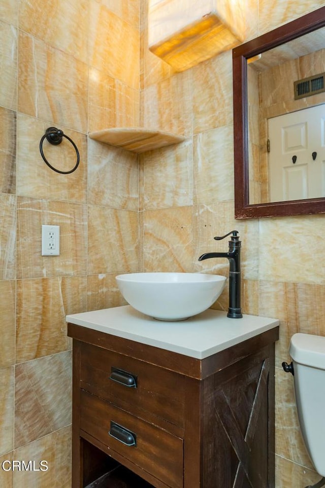 29421 Florabunda Rd, Canyon Country, CA 91387 - half bathroom with tile walls, vanity, toilet, and backsplash