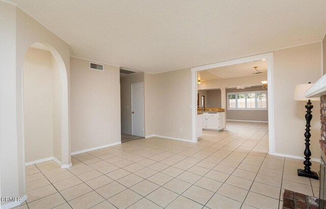 29421 Florabunda Rd, Canyon Country, CA 91387 - spare room with light tile patterned flooring, arched walkways, and baseboards
