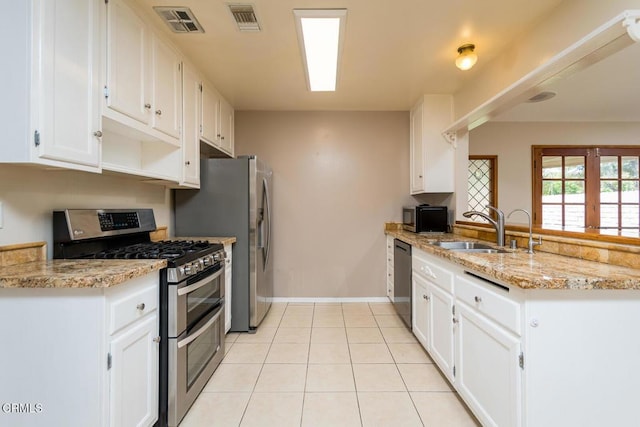 29421 Florabunda Rd, Canyon Country, CA 91387 - kitchen with stainless steel appliances, a sink, a peninsula, white cabinetry, and light tile patterned floors