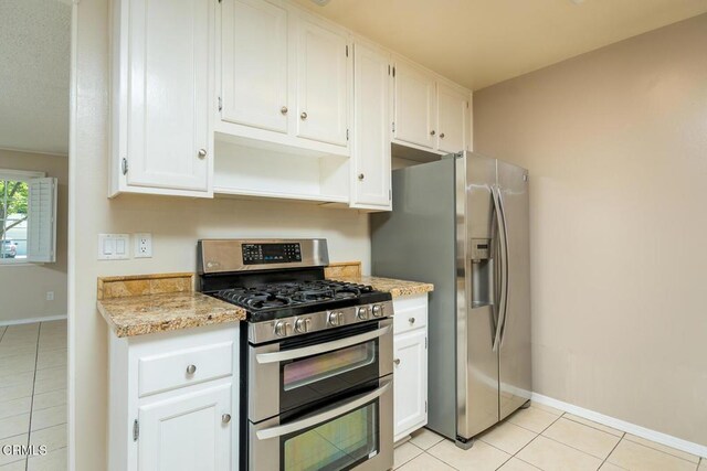 29421 Florabunda Rd, Canyon Country, CA 91387 - kitchen featuring appliances with stainless steel finishes, light tile patterned flooring, white cabinetry, and light stone countertops