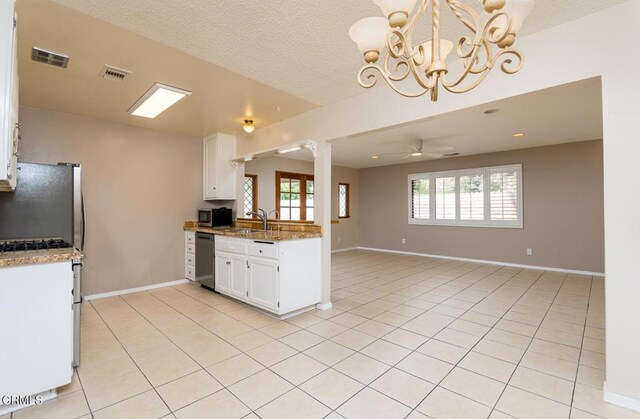 29421 Florabunda Rd, Canyon Country, CA 91387 - kitchen featuring appliances with stainless steel finishes, plenty of natural light, a chandelier, white cabinets, and a textured ceiling