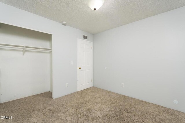 29421 Florabunda Rd, Canyon Country, CA 91387 - unfurnished bedroom featuring carpet, a closet, and a textured ceiling