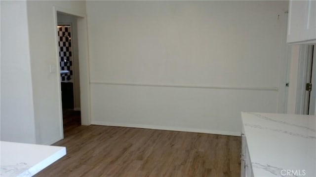 2420 Maine Ave, Long Beach, CA 90806 - unfurnished dining area with light wood-style flooring and baseboards