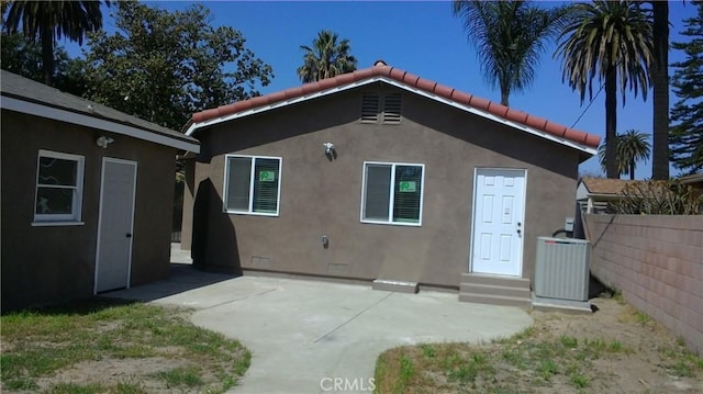 2420 Maine Ave, Long Beach, CA 90806 - rear view of property featuring stucco siding, a tiled roof, a patio, entry steps, and cooling unit