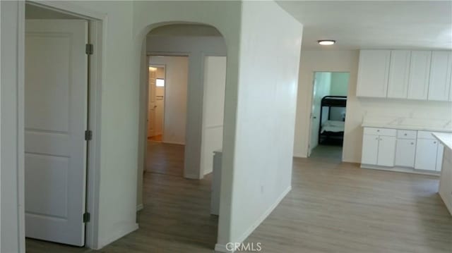 2420 Maine Ave, Long Beach, CA 90806 - hall featuring arched walkways, light wood-type flooring, and baseboards