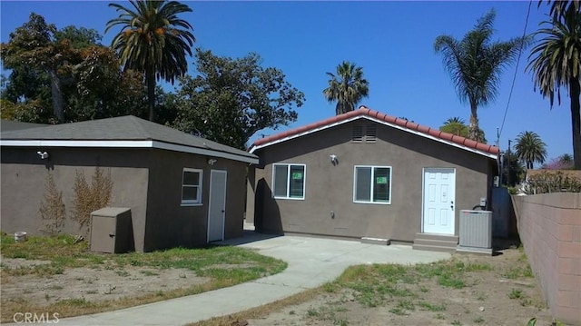 2420 Maine Ave, Long Beach, CA 90806 - rear view of house featuring stucco siding, a tile roof, and entry steps