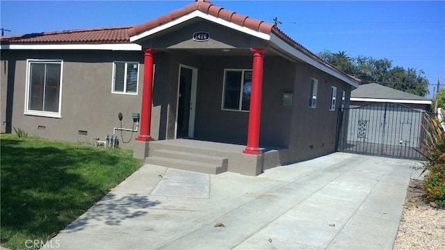 2420 Maine Ave, Long Beach, CA 90806 - view of front of home with stucco siding, a gate, a tile roof, and crawl space