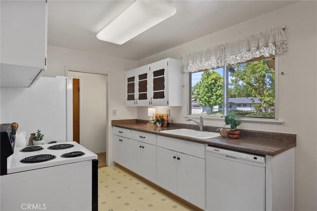 2661 San Jose St, Chico, CA 95973 - kitchen with white appliances, a sink, dark countertops, and white cabinetry