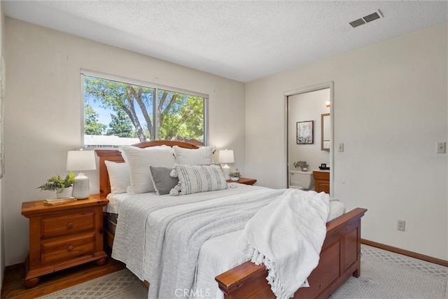 2661 San Jose St, Chico, CA 95973 - bedroom featuring a textured ceiling, baseboards, and ensuite bath