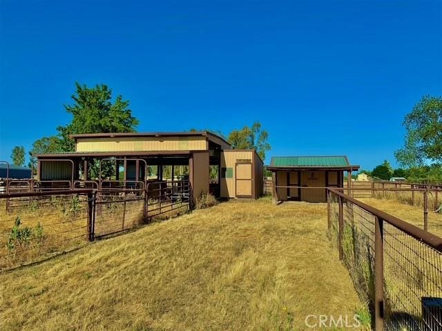 3646 Kirkwood Rd, Corning, CA 96021 - view of yard featuring an exterior structure, an outdoor structure, and a view of rural / pastoral area