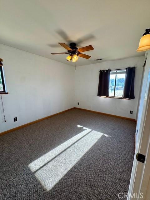 3646 Kirkwood Rd, Corning, CA 96021 - carpeted spare room with a ceiling fan and baseboards