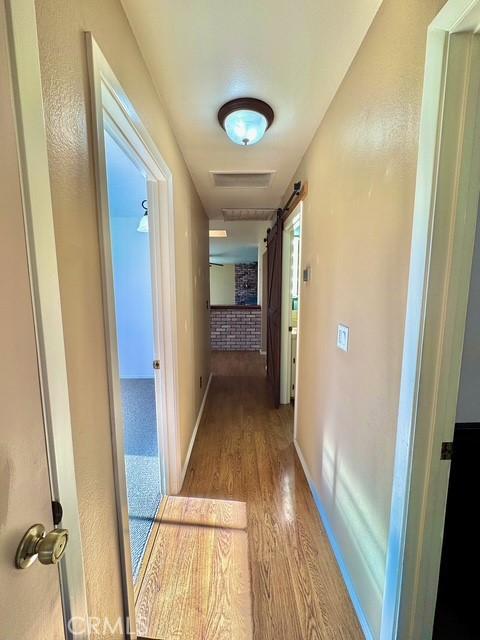 3646 Kirkwood Rd, Corning, CA 96021 - corridor featuring wood finished floors and baseboards