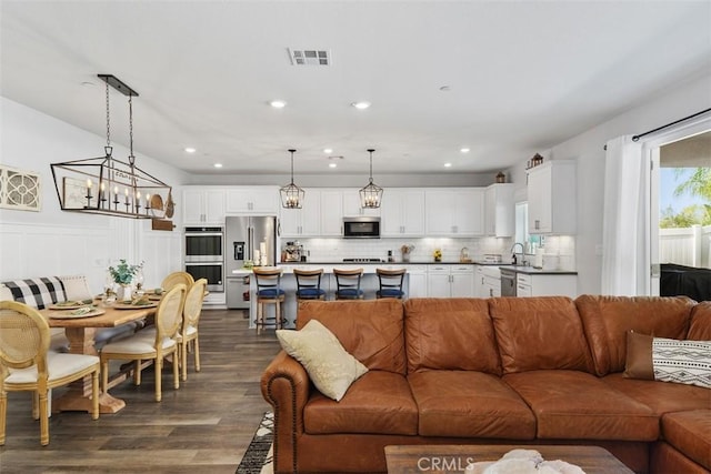 32954 Marin Fields Rd, Winchester, CA 92596 - living area featuring dark wood-type flooring, recessed lighting, and a wainscoted wall