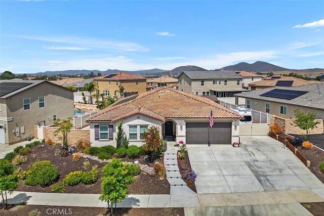 32954 Marin Fields Rd, Winchester, CA 92596 - view of front facade with an attached garage, driveway, a mountain view, and a gate