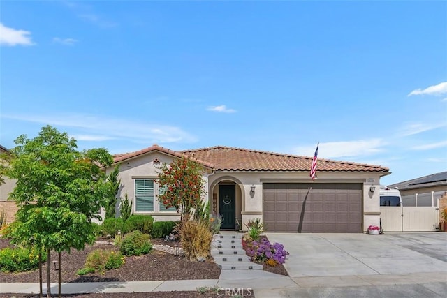 32954 Marin Fields Rd, Winchester, CA 92596 - mediterranean / spanish-style house with stucco siding, an attached garage, concrete driveway, and a gate