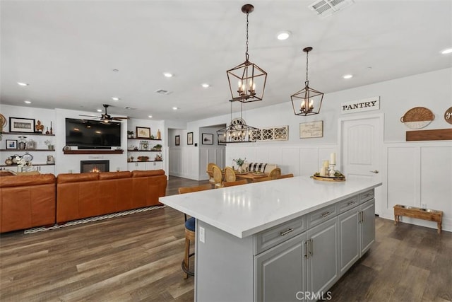 32954 Marin Fields Rd, Winchester, CA 92596 - kitchen featuring gray cabinetry, wainscoting, a center island, light countertops, and a ceiling fan