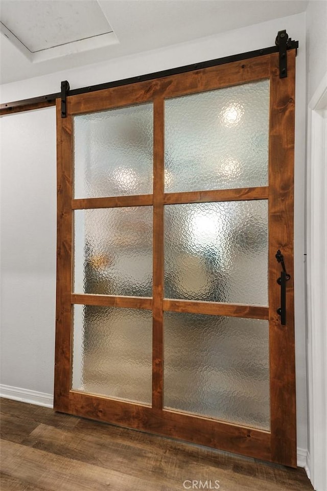 32954 Marin Fields Rd, Winchester, CA 92596 - detailed view of wood finished floors, a barn door, and baseboards