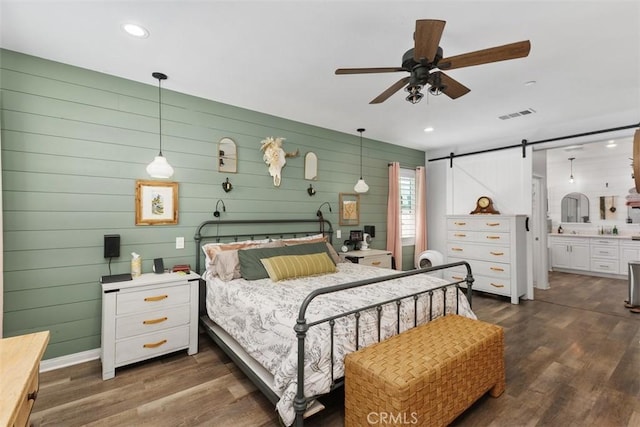 32954 Marin Fields Rd, Winchester, CA 92596 - bedroom featuring a barn door, dark wood-type flooring, recessed lighting, ensuite bath, and ceiling fan