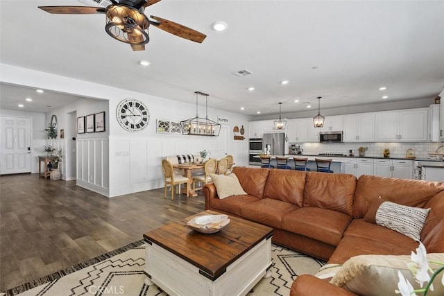 32954 Marin Fields Rd, Winchester, CA 92596 - living room with wood finished floors, recessed lighting, ceiling fan, and wainscoting