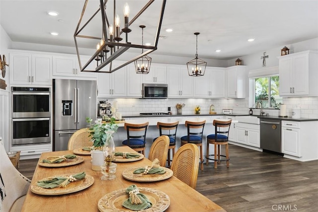 32954 Marin Fields Rd, Winchester, CA 92596 - kitchen featuring stainless steel appliances, white cabinets, decorative backsplash, recessed lighting, and dark wood-style flooring