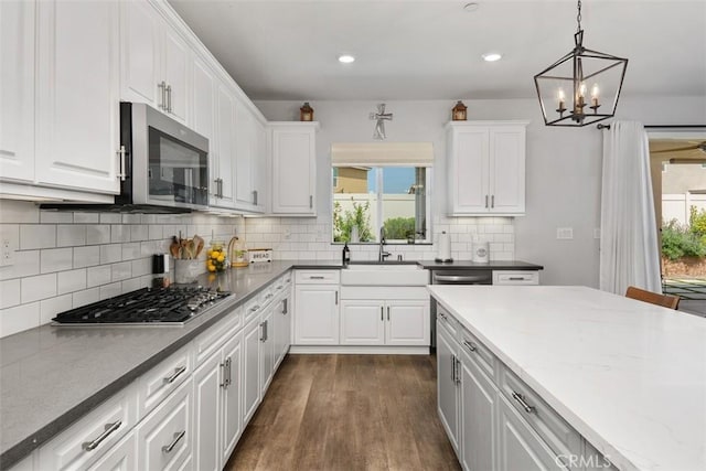 32954 Marin Fields Rd, Winchester, CA 92596 - kitchen with appliances with stainless steel finishes, a sink, a chandelier, white cabinetry, and recessed lighting