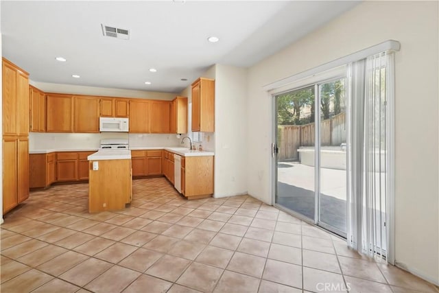 28445 Silverking Trl, Saugus, CA 91390 - kitchen with white appliances, light countertops, a kitchen island, recessed lighting, and light tile patterned flooring