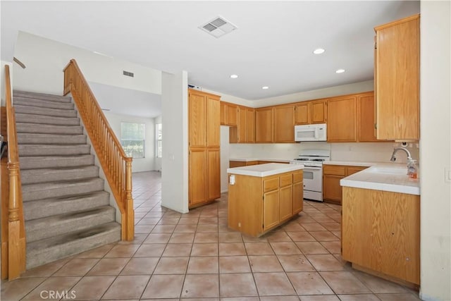 28445 Silverking Trl, Saugus, CA 91390 - kitchen with white appliances, light tile patterned floors, light countertops, a center island, and recessed lighting