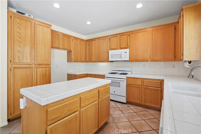 28445 Silverking Trl, Saugus, CA 91390 - kitchen with white appliances, light tile patterned floors, tile counters, recessed lighting, and a center island