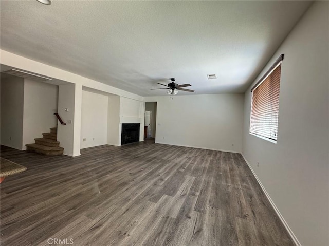 2306 Camellia St, Palmdale, CA 93551 - unfurnished living room with ceiling fan, wood finished floors, stairway, a fireplace, and baseboards