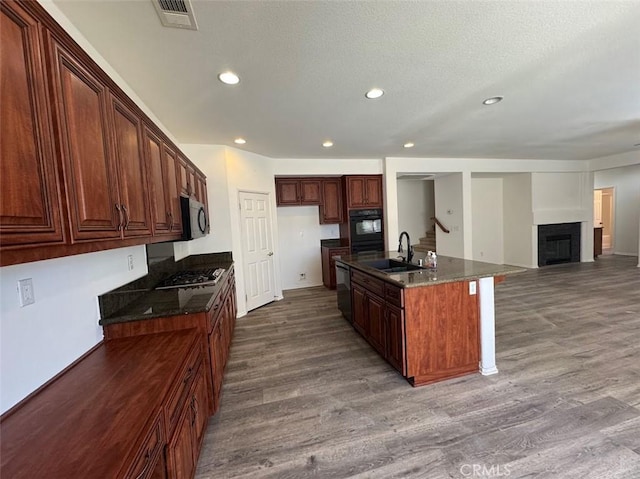 2306 Camellia St, Palmdale, CA 93551 - kitchen featuring a sink, dark wood finished floors, stainless steel appliances, recessed lighting, and a fireplace