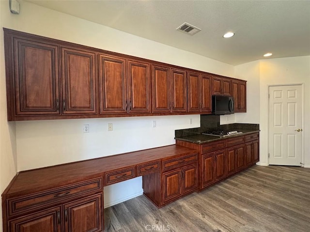 2306 Camellia St, Palmdale, CA 93551 - kitchen featuring black microwave, dark countertops, dark wood-style floors, stainless steel gas cooktop, and recessed lighting