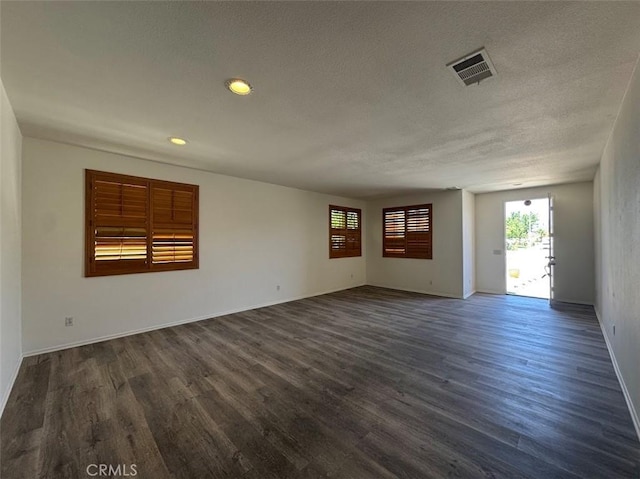 2306 Camellia St, Palmdale, CA 93551 - empty room featuring dark wood-style floors, a textured ceiling, recessed lighting, and baseboards