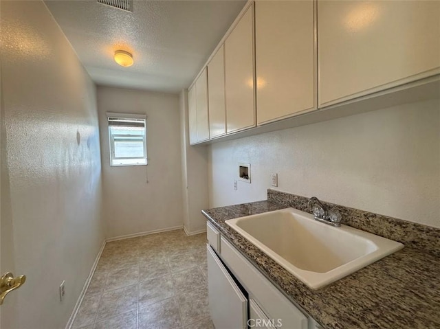2306 Camellia St, Palmdale, CA 93551 - kitchen with a sink, baseboards, white cabinets, and a textured ceiling