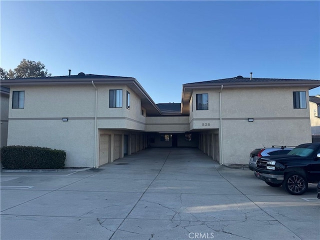 525 Grande Ave Unit D, Nipomo, CA 93444 - rear view of property with stucco siding, a garage, and driveway