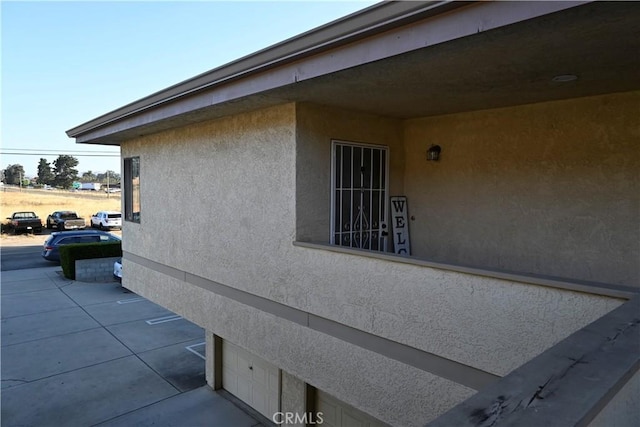 525 Grande Ave Unit D, Nipomo, CA 93444 - view of home's exterior featuring a garage and stucco siding