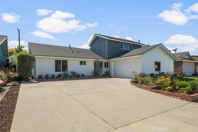16791 Glenhaven Ln, Huntington Beach, CA 92647 - view of front of property with board and batten siding, driveway, and an attached garage