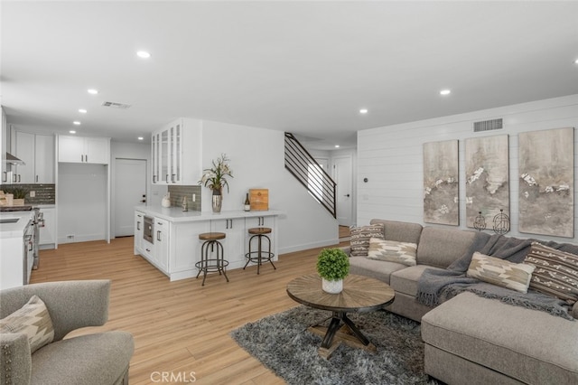 16791 Glenhaven Ln, Huntington Beach, CA 92647 - living area with recessed lighting, light wood-style flooring, stairs, and baseboards