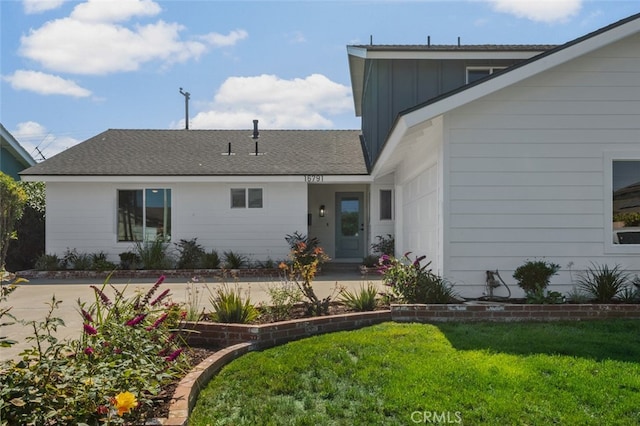 16791 Glenhaven Ln, Huntington Beach, CA 92647 - view of front facade featuring board and batten siding, a front yard, and a shingled roof