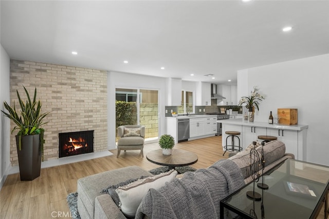 16791 Glenhaven Ln, Huntington Beach, CA 92647 - living area featuring a fireplace, light wood-type flooring, and recessed lighting
