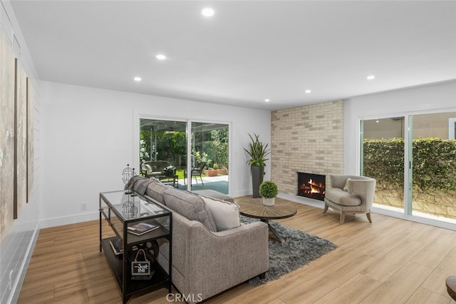 16791 Glenhaven Ln, Huntington Beach, CA 92647 - living room with a fireplace, recessed lighting, wood finished floors, and baseboards