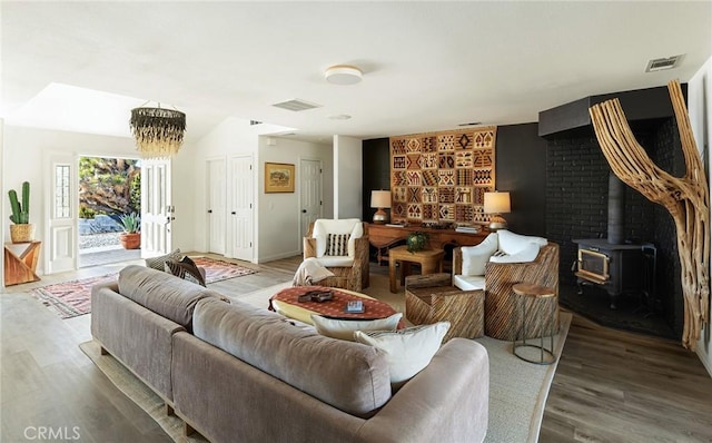 58916 Carmelita Cir, Yucca Valley, CA 92284 - living room featuring a wood stove, wood finished floors, and baseboards