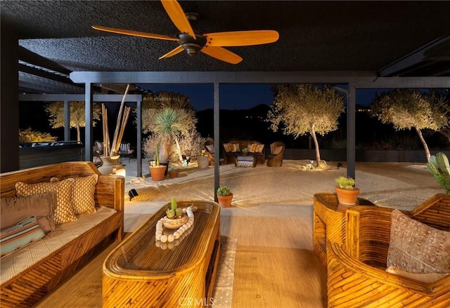 58916 Carmelita Cir, Yucca Valley, CA 92284 - patio at night with a ceiling fan, a patio, and an outdoor hangout area