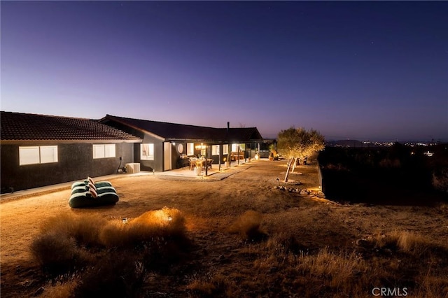58916 Carmelita Cir, Yucca Valley, CA 92284 - back of house with a tiled roof, cooling unit, a patio, and stucco siding