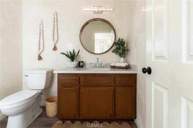 58916 Carmelita Cir, Yucca Valley, CA 92284 - half bath featuring vanity, toilet, baseboards, and wood finished floors