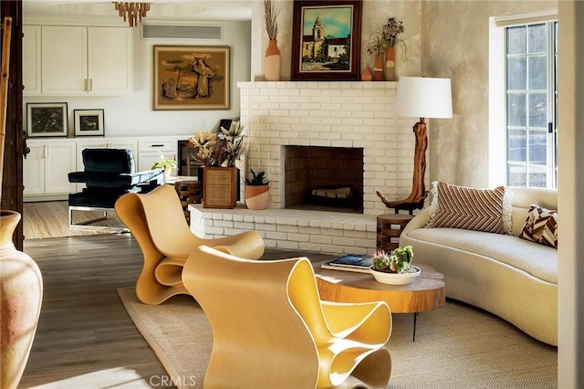 58916 Carmelita Cir, Yucca Valley, CA 92284 - living room featuring wood finished floors and a brick fireplace