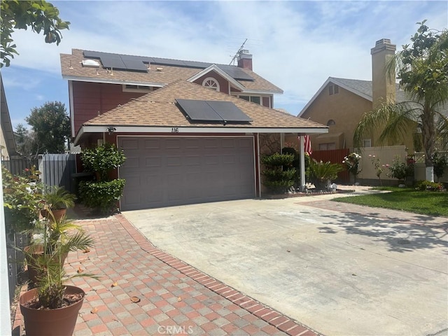 116 Evergreen Pl, Perris, CA 92571 - traditional-style house featuring roof mounted solar panels, concrete driveway, an attached garage, and roof with shingles