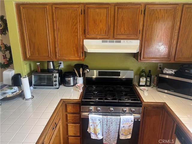 116 Evergreen Pl, Perris, CA 92571 - kitchen with tile countertops, stainless steel appliances, under cabinet range hood, and brown cabinets