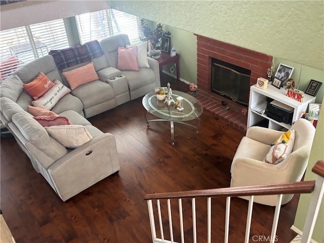 116 Evergreen Pl, Perris, CA 92571 - living room featuring lofted ceiling, hardwood / wood-style floors, a brick fireplace, and baseboards